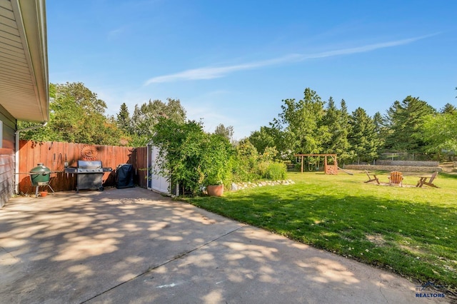 3112 Flint Dr, Rapid City, SD 57702 - view of yard with a shed, an outdoor structure, fence, a playground, and a patio
