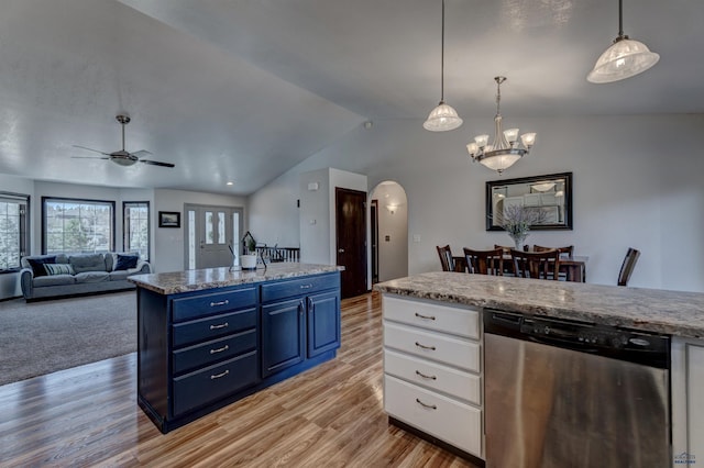 kitchen with arched walkways, white cabinetry, vaulted ceiling, stainless steel dishwasher, and blue cabinets