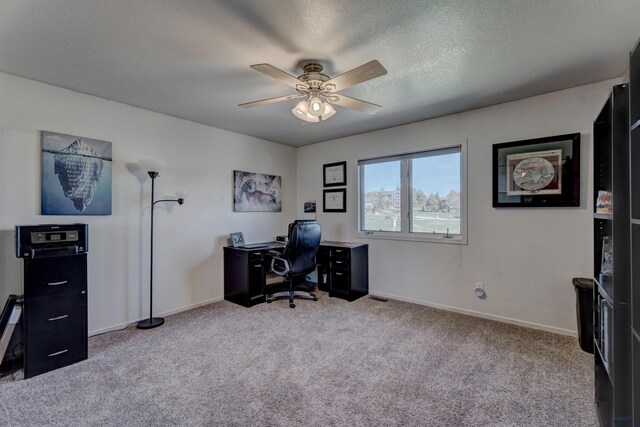 office with ceiling fan, carpet, baseboards, and a textured ceiling
