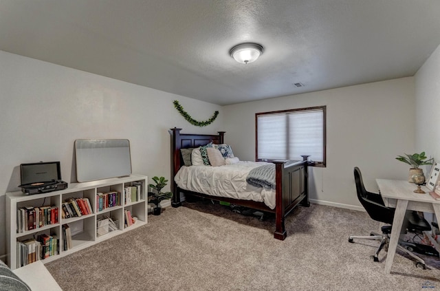 carpeted bedroom with baseboards and a textured ceiling