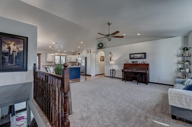 living area featuring baseboards, a ceiling fan, recessed lighting, vaulted ceiling, and light colored carpet