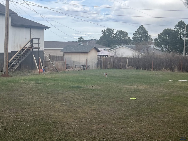 view of yard with stairway and fence
