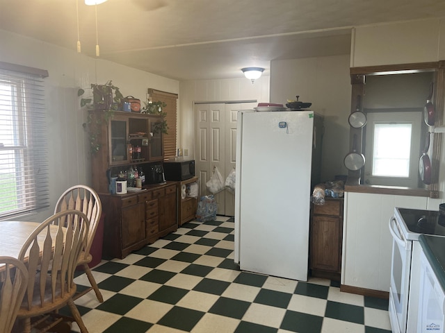kitchen with light floors and white appliances