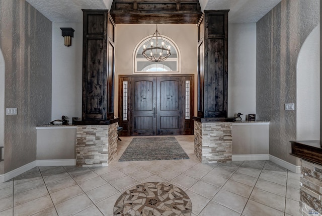 1334 Alta Vista Dr, Rapid City, SD 57701 - foyer featuring tile patterned flooring, a high ceiling, an inviting chandelier, and a textured wall