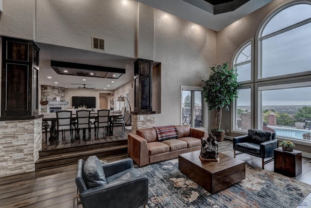 1334 Alta Vista Dr, Rapid City, SD 57701 - living room with visible vents, a high ceiling, hardwood / wood-style floors, and a textured wall