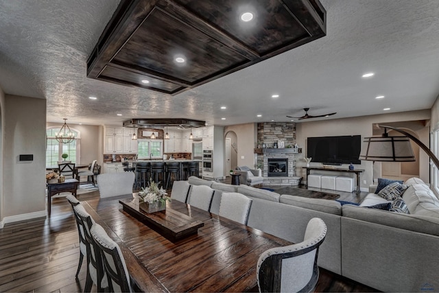 1334 Alta Vista Dr, Rapid City, SD 57701 - dining room with baseboards, a stone fireplace, dark wood finished floors, recessed lighting, and ceiling fan with notable chandelier