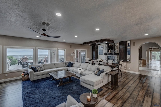 1334 Alta Vista Dr, Rapid City, SD 57701 - living area with visible vents, arched walkways, hardwood / wood-style floors, and a textured ceiling