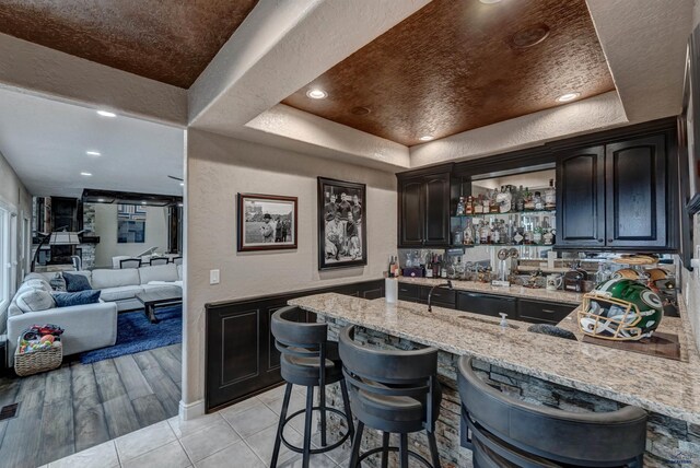 1334 Alta Vista Dr, Rapid City, SD 57701 - bar with wet bar, recessed lighting, a raised ceiling, a textured wall, and baseboards