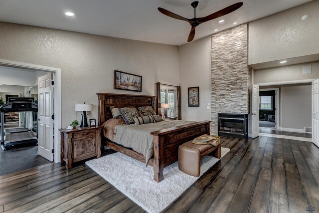 1334 Alta Vista Dr, Rapid City, SD 57701 - bedroom with a textured wall, a towering ceiling, a large fireplace, and wood finished floors