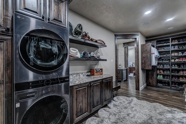 1334 Alta Vista Dr, Rapid City, SD 57701 - laundry area featuring baseboards, stacked washer and clothes dryer, recessed lighting, wood finished floors, and cabinet space