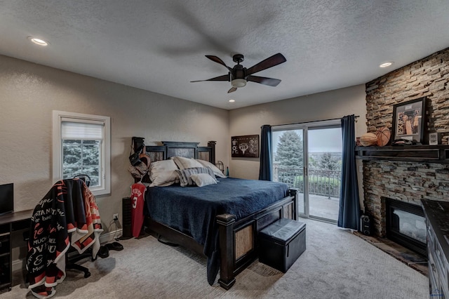 1334 Alta Vista Dr, Rapid City, SD 57701 - bedroom with ceiling fan, a textured ceiling, a fireplace, carpet floors, and access to exterior