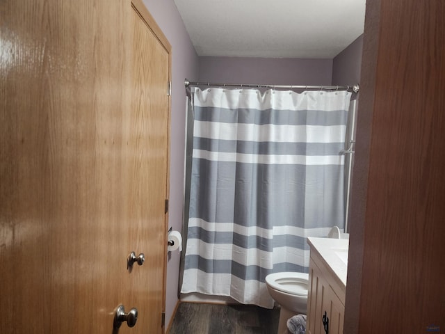 322 Summit, Belle Fourche, SD 57717 - bathroom with toilet, a shower with shower curtain, vanity, and wood finished floors