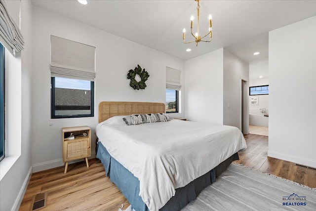 bedroom with light wood-style floors, visible vents, recessed lighting, a chandelier, and baseboards