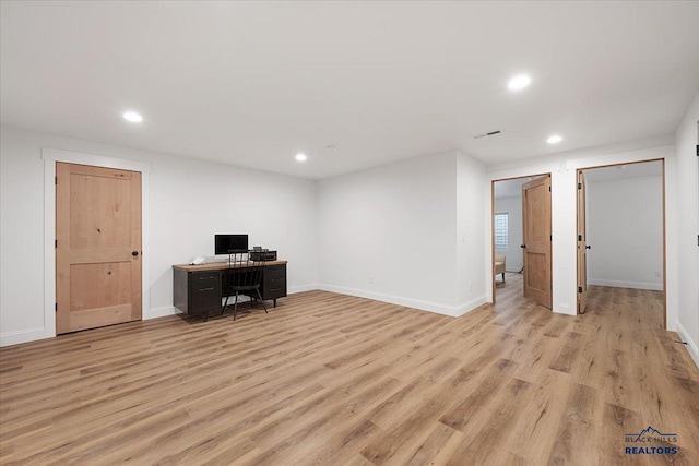 unfurnished office featuring light wood-style floors, baseboards, and recessed lighting