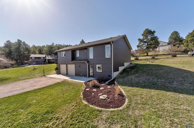 7497 Tanager Dr, Rapid City, SD 57702 - view of front of property featuring a garage, a front yard, and dirt driveway