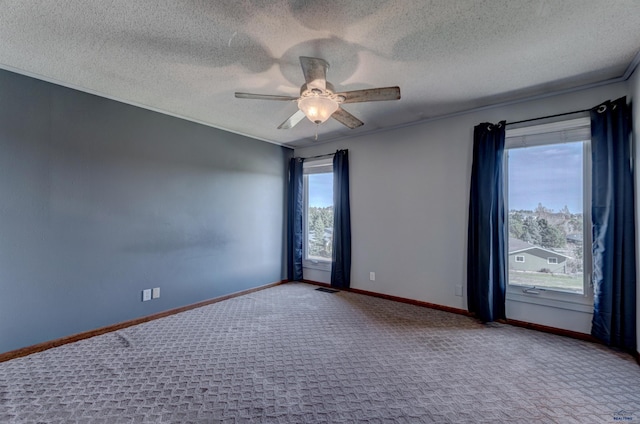 7497 Tanager Dr, Rapid City, SD 57702 - carpeted empty room with visible vents, a textured ceiling, baseboards, and ceiling fan