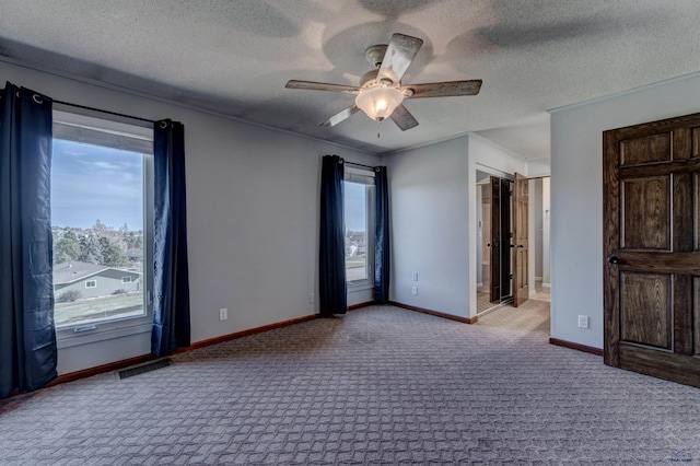 7497 Tanager Dr, Rapid City, SD 57702 - unfurnished bedroom featuring ceiling fan, carpet, a textured ceiling, visible vents, and baseboards