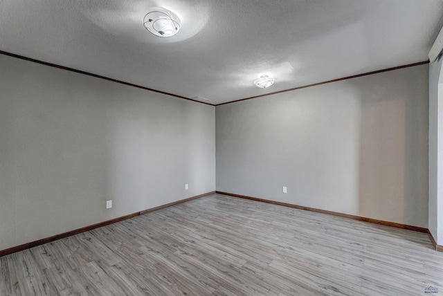 7497 Tanager Dr, Rapid City, SD 57702 - unfurnished room with ornamental molding, light wood-style flooring, baseboards, and a textured ceiling