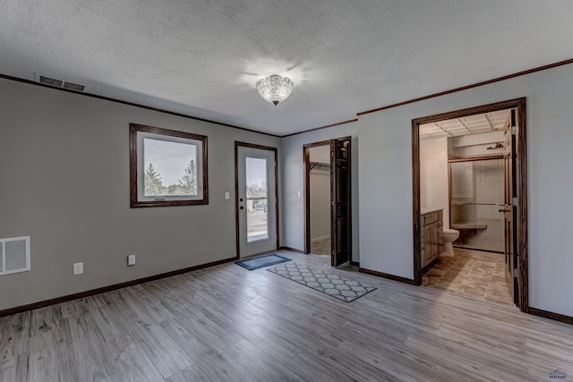 7497 Tanager Dr, Rapid City, SD 57702 - entryway featuring visible vents, baseboards, light wood-style floors, and a textured ceiling