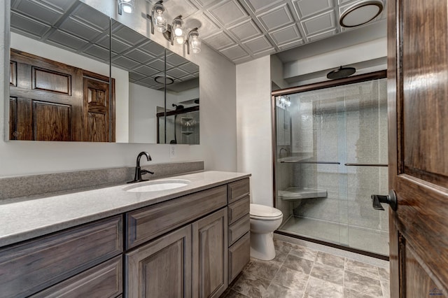 7497 Tanager Dr, Rapid City, SD 57702 - full bathroom featuring a stall shower, vanity, an ornate ceiling, and toilet