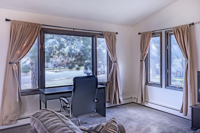 carpeted office with a baseboard heating unit and vaulted ceiling