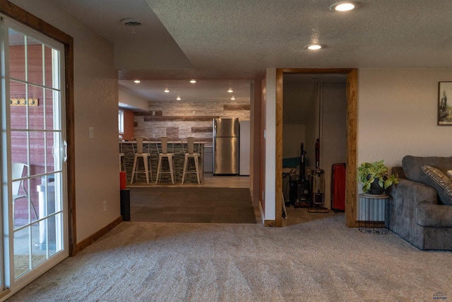2412 Cameron Dr, Rapid City, SD 57702 - carpeted living room featuring a textured ceiling, a dry bar, baseboards, and recessed lighting