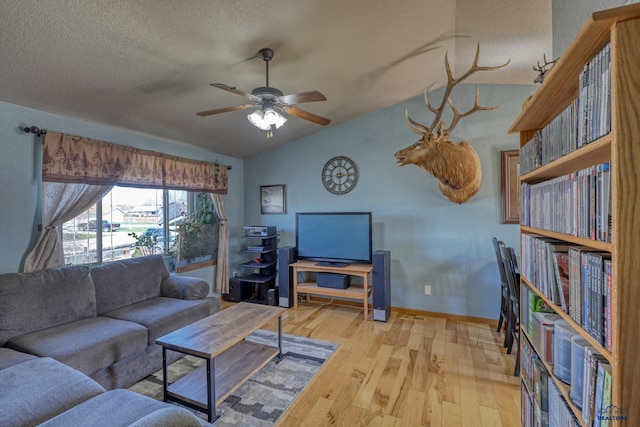 2906 Benjamin, Rapid City, SD 57703 - living area featuring a textured ceiling, vaulted ceiling, a ceiling fan, and wood finished floors