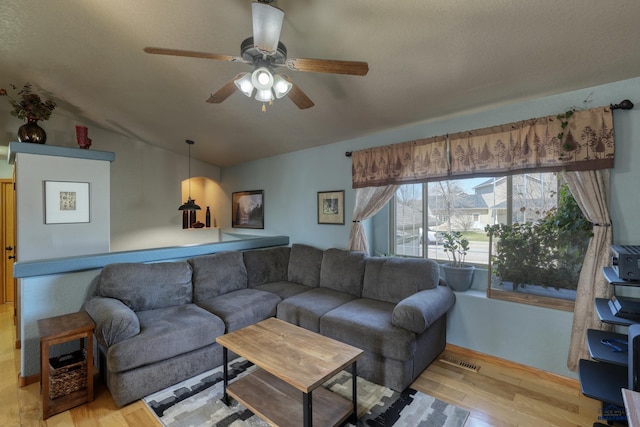 2906 Benjamin, Rapid City, SD 57703 - living area featuring visible vents, ceiling fan, vaulted ceiling, and wood finished floors