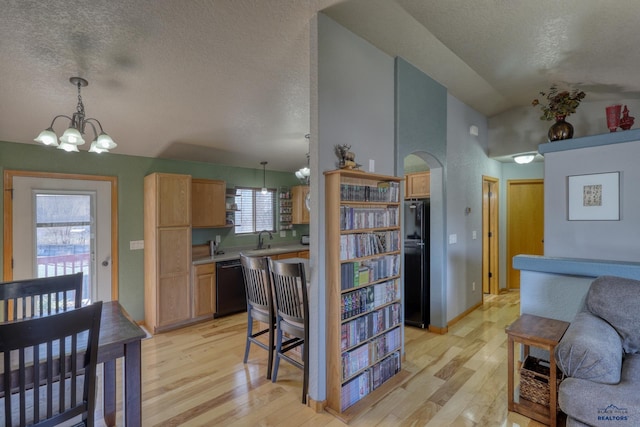 2906 Benjamin, Rapid City, SD 57703 - kitchen featuring a chandelier, light wood-style floors, a textured ceiling, and black appliances