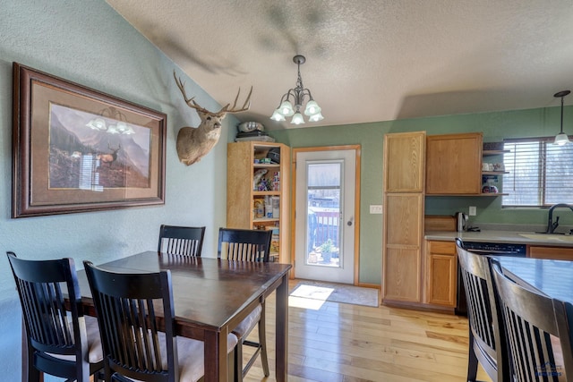 2906 Benjamin, Rapid City, SD 57703 - dining room with a notable chandelier, baseboards, a textured wall, a textured ceiling, and light wood finished floors