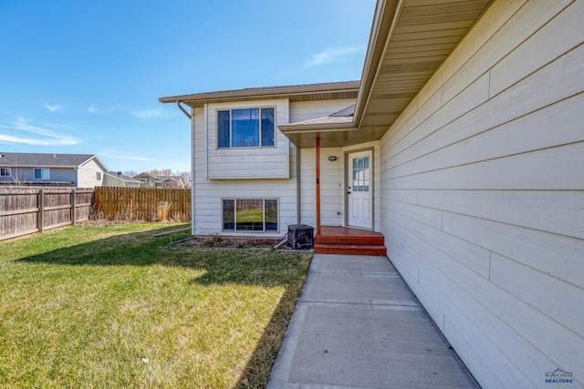 2906 Benjamin, Rapid City, SD 57703 - doorway to property with a yard, fence, and a shingled roof