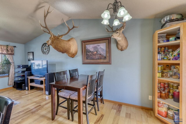 2906 Benjamin, Rapid City, SD 57703 - dining space featuring baseboards, vaulted ceiling, a notable chandelier, and wood finished floors