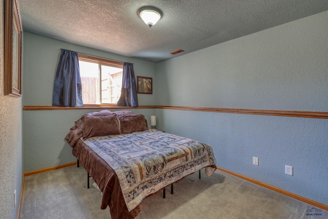 2906 Benjamin, Rapid City, SD 57703 - carpeted bedroom featuring a textured ceiling, a textured wall, and baseboards