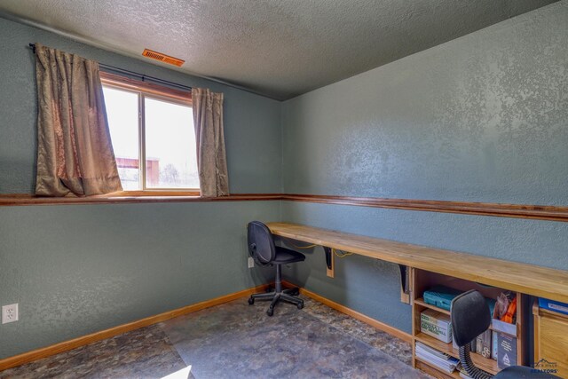 2906 Benjamin, Rapid City, SD 57703 - unfurnished office featuring a textured ceiling, a textured wall, baseboards, and visible vents