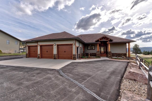 20694 Roosevelt Ct, Sturgis, SD 57785 - prairie-style house with roof with shingles, driveway, a garage, and stone siding
