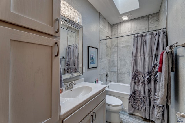 20694 Roosevelt Ct, Sturgis, SD 57785 - bathroom featuring toilet, shower / tub combo with curtain, a textured wall, vanity, and wood finished floors