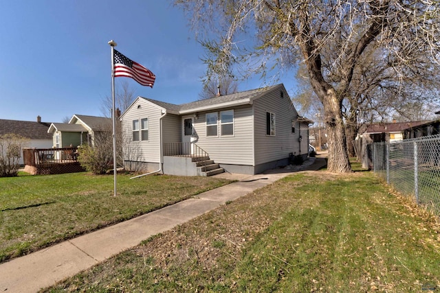 1021 Haines Ave, Rapid City, SD 57701 - bungalow-style home with a front yard, fence, and a wooden deck