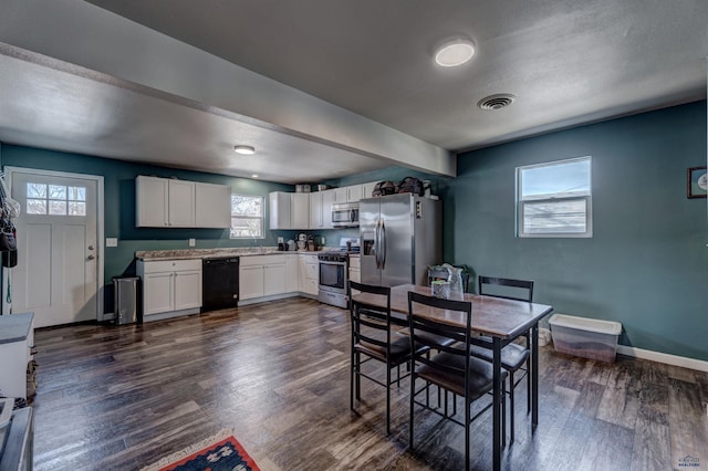 1021 Haines Ave, Rapid City, SD 57701 - dining area featuring dark wood-type flooring, baseboards, and visible vents
