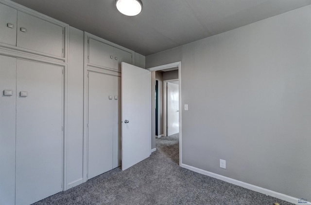 1021 Haines Ave, Rapid City, SD 57701 - unfurnished bedroom with a closet, baseboards, and carpet flooring