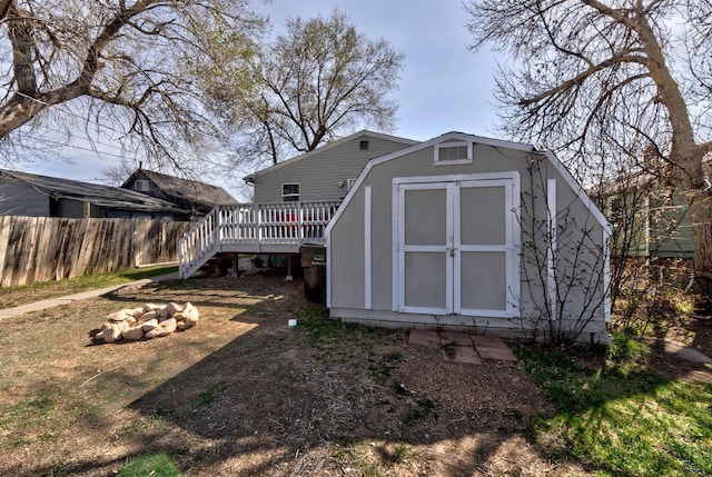 1021 Haines Ave, Rapid City, SD 57701 - view of shed with fence, a fire pit, and stairs