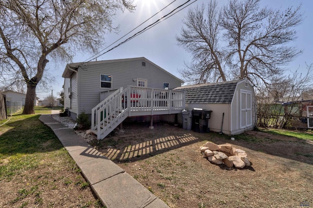 1021 Haines Ave, Rapid City, SD 57701 - rear view of house with an outbuilding, a wooden deck, a gambrel roof, and a shed