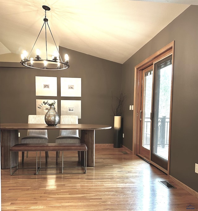 8000 Meadow View Ct, Rapid City, SD 57702 - dining room with visible vents, light wood-type flooring, an inviting chandelier, and a healthy amount of sunlight