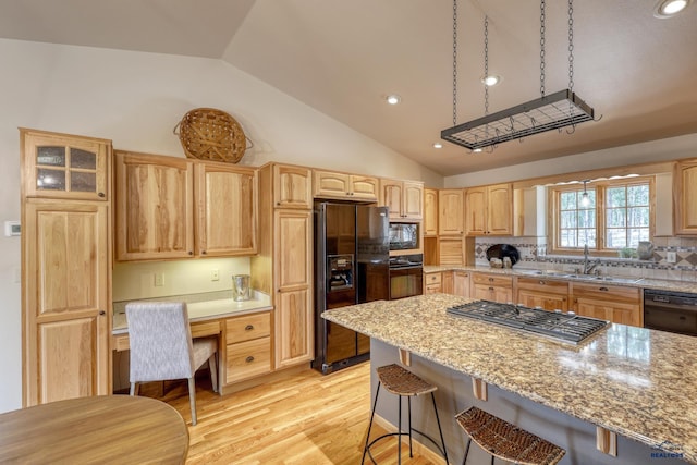 8000 Meadow View Ct, Rapid City, SD 57702 - kitchen featuring a sink, a kitchen breakfast bar, light brown cabinetry, black appliances, and lofted ceiling