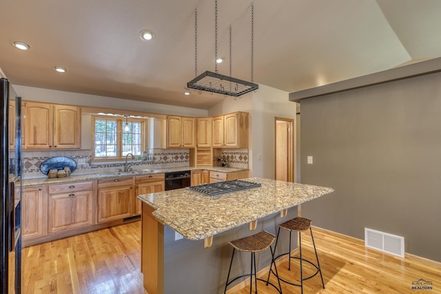 8000 Meadow View Ct, Rapid City, SD 57702 - kitchen featuring black appliances, visible vents, light brown cabinets, and a sink