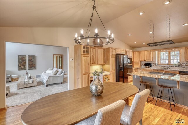 8000 Meadow View Ct, Rapid City, SD 57702 - dining area featuring light wood-style flooring, a notable chandelier, lofted ceiling, and recessed lighting
