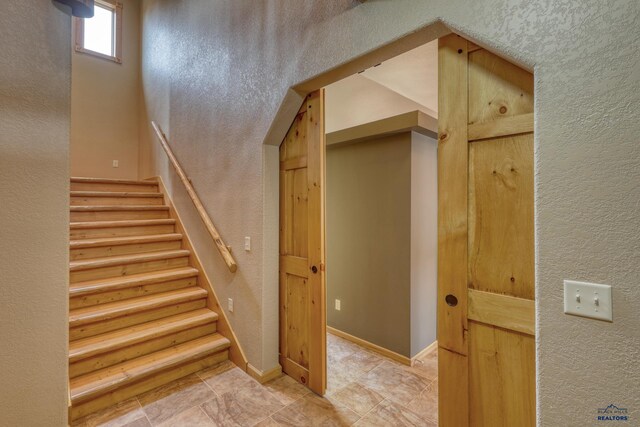 8000 Meadow View Ct, Rapid City, SD 57702 - staircase featuring a textured wall