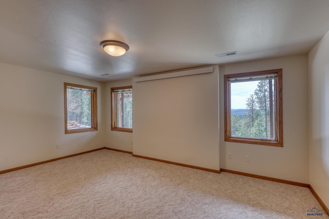 8000 Meadow View Ct, Rapid City, SD 57702 - carpeted spare room featuring visible vents, baseboards, and a textured ceiling
