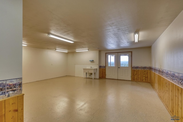 8000 Meadow View Ct, Rapid City, SD 57702 - interior space featuring french doors, wood walls, a sink, and wainscoting