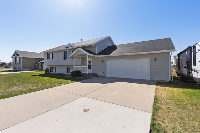 323 Freiheit Ln, Box Elder, SD 57719 - split level home featuring an attached garage, a shingled roof, concrete driveway, and a front lawn
