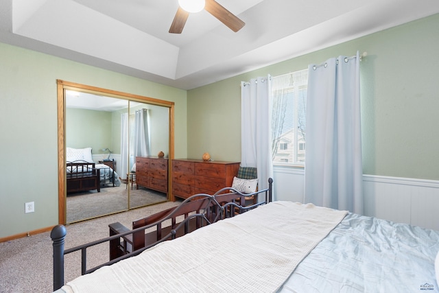 323 Freiheit Ln, Box Elder, SD 57719 - carpeted bedroom with a raised ceiling, a closet, and a ceiling fan